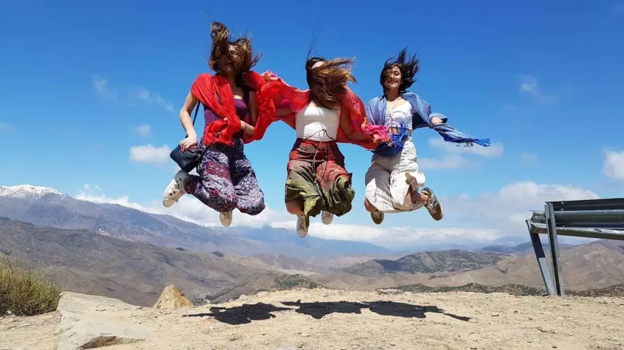 A group of friends jumping for a photo in the Atlas Mountains